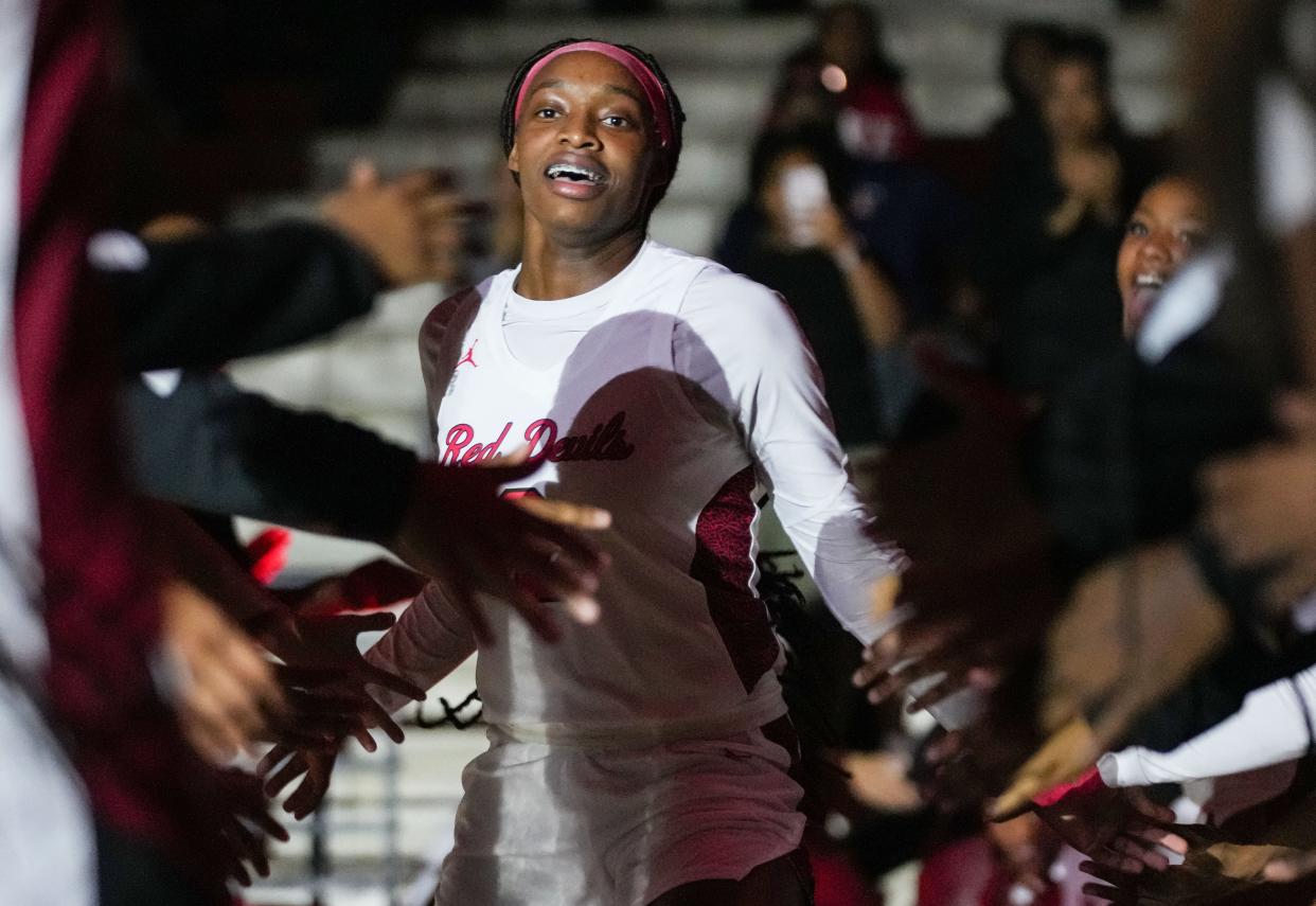 Pike Red Devils Komari Booker (2) runs out to the court during team introductions Tuesday, Nov. 14, 2023, during the game at Pike High School in Indianapolis.