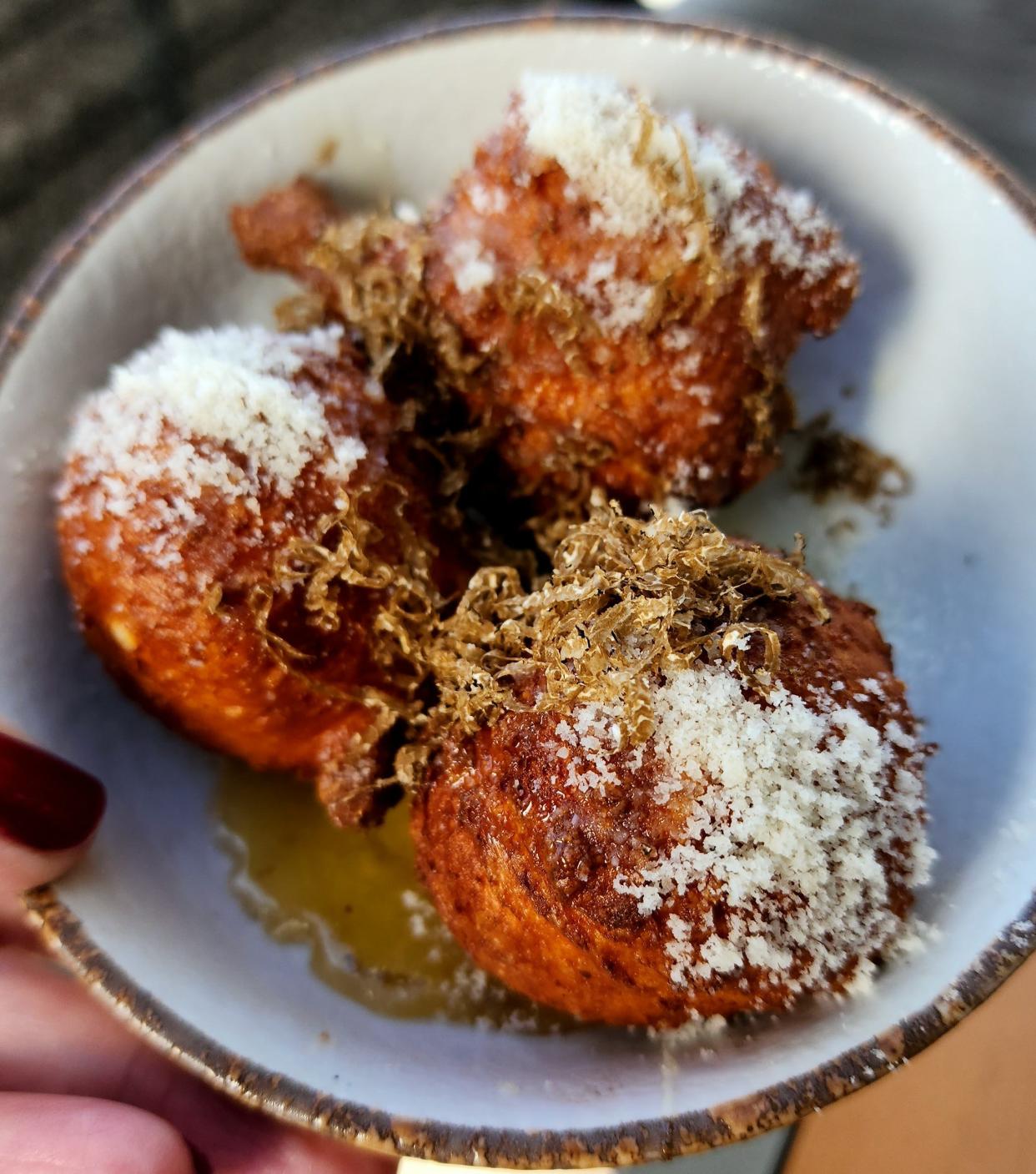Ricotta Frittelle at Giusto in Newport, fried cheese balls served with drizzles of honey, truffles and Parmesan cheese.