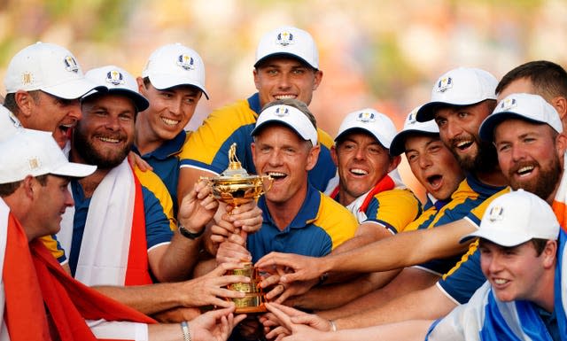 Captain Luke Donald and his European players celebrate their victory with the trophy after winning the 2023 Ryder Cup