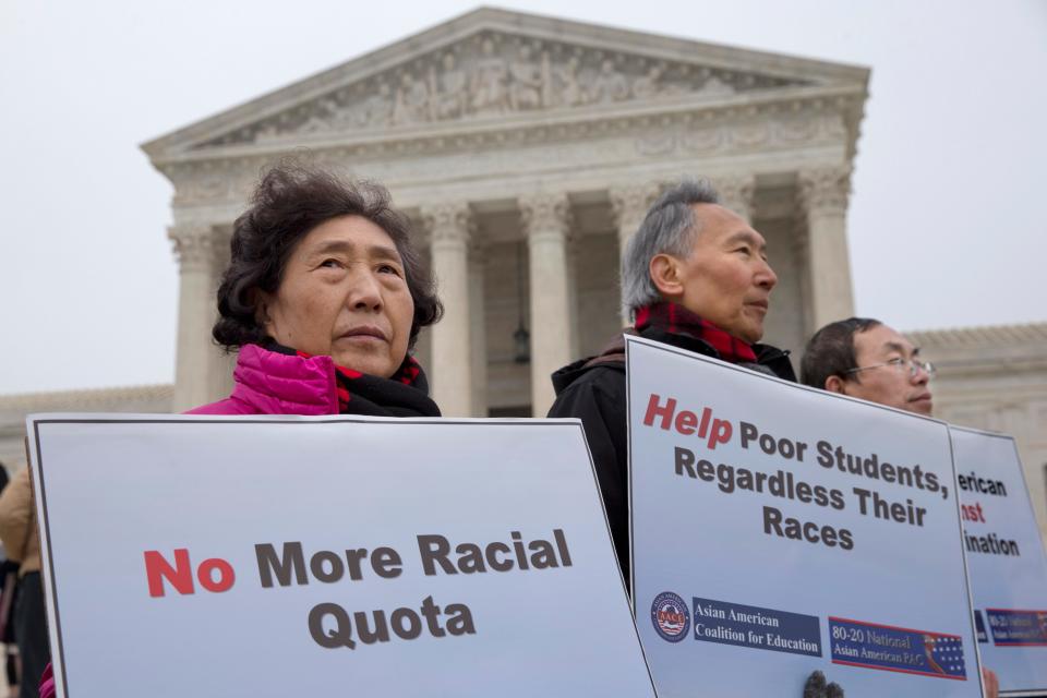 Guixue Zhou of North Potomac, Maryland., left, and others protests against racial quotas outside the Supreme Court in 2015, as the court heard oral arguments in the Fisher v. University of Texas at Austin case.