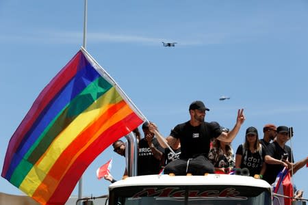 Ricky Martin waves a rainbow flag during a protest calling for the resignation of Governor Ricardo Rossello in San Juan