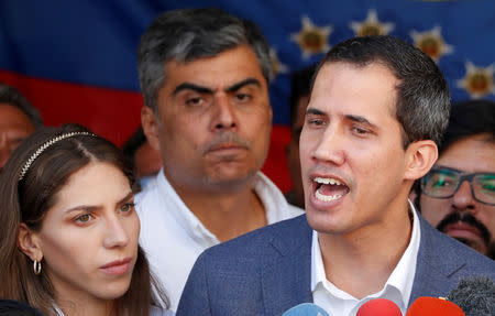 FILE PHOTO: Venezuelan opposition leader Juan Guaido, who many nations have recognized as the country's rightful interim ruler, talks to the media after attending a religious event in Caracas, Venezuela February 10, 2019. REUTERS/Carlos Garcia Rawlins/File Photo