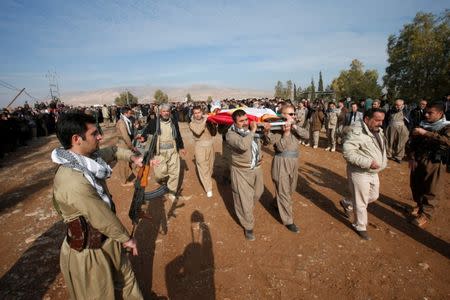 Mourners carry the bodies of the victims who were killed in a bomb attack at the offices of the Democratic Party of Iranian Kurdistan (PDKI) in Koy Sanjak, east of Erbil, Iraq, December 21, 2016. REUTERS/Azad Lashkari