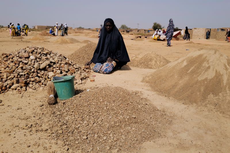 Ouedraogo Rasmata. 55, who fled from attacks of armed militants in Sahel region of Soum breaks rocks to turn into powder for sale to construction workers in an informal camp for displaced people on the outskirts of Ouagadougou