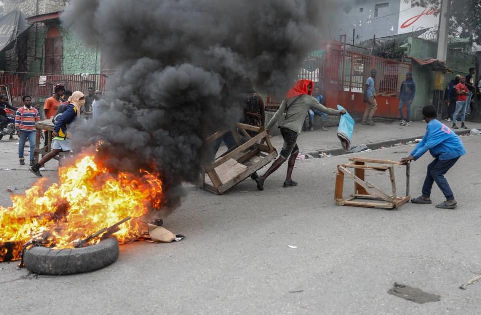 Protesters set up a barricade in the street during a demonstration demanding the resignation of Prime Minister Ariel Henry in Port-au-Prince, Haiti, Wednesday, Feb. 7, 2024. (AP Photo/Odelyn Joseph)