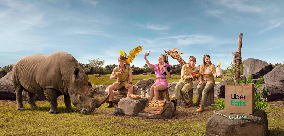 Bindi, Robert and Terri Irwin sitting with Paris Hilton surrounded by animals in Australia Zoo.