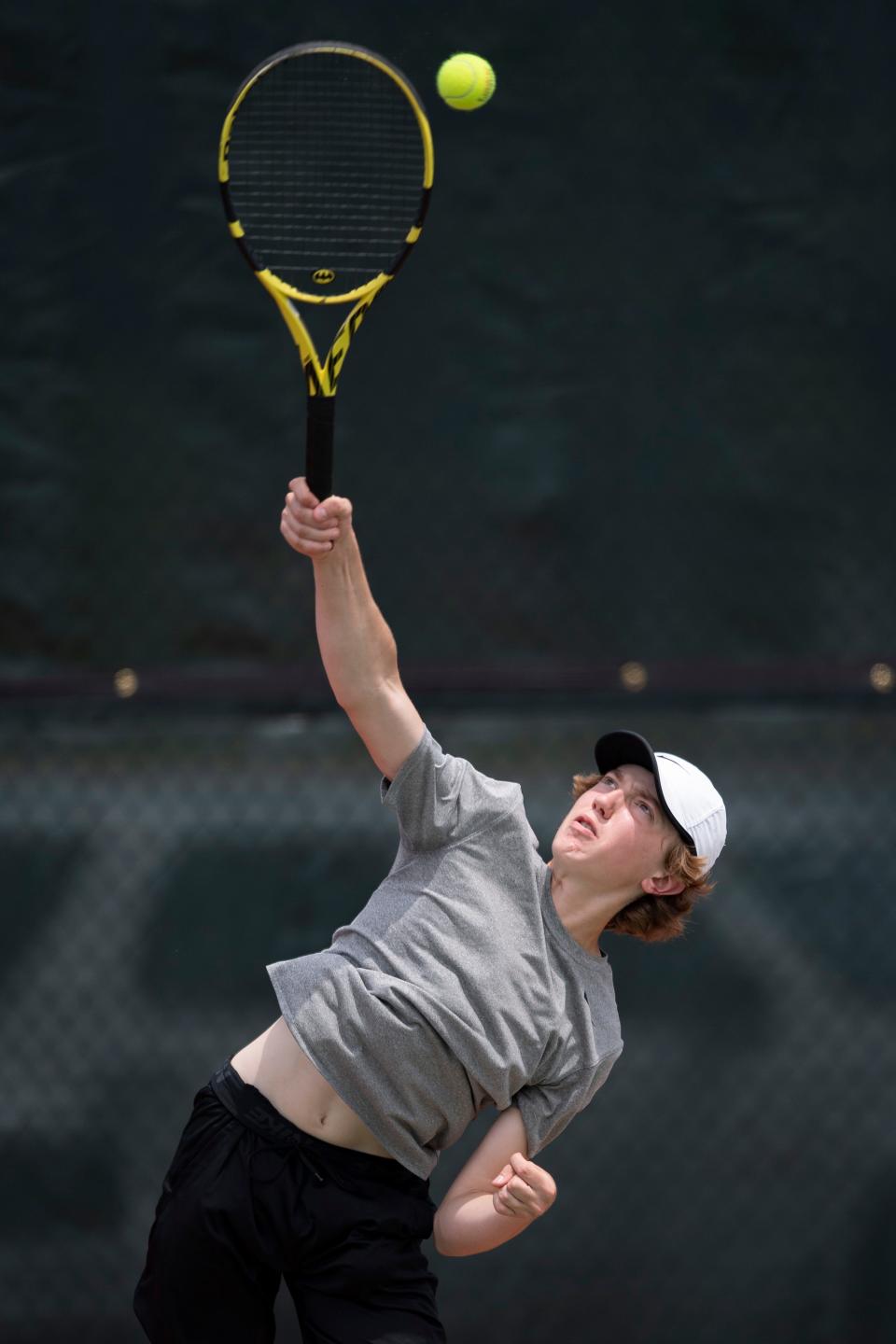 Topeka West's James Maag serves the ball at the state tournament Friday at Kossover Tennis Court.