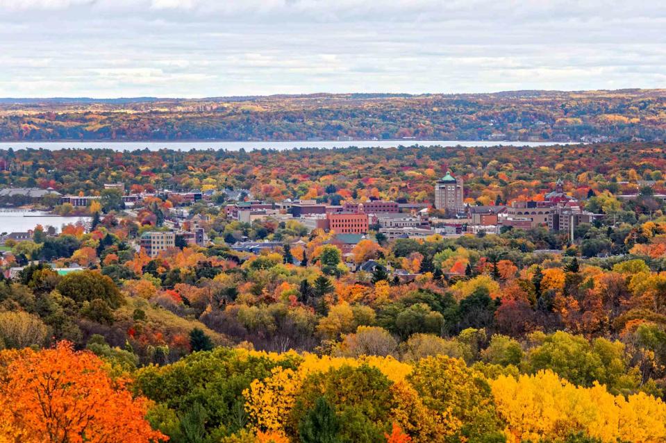 <p>garyrennis/Getty Images</p> Aerial view of Autumn sweeping through Traverse City, Michigan