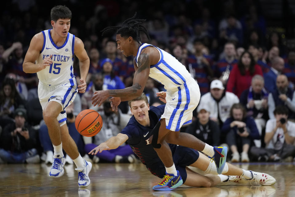 FILE - Pennsylvania's Andrew Laczkowski, center, dives for a loose ball against Kentucky's Rob Dillingham, right, and Reed Sheppard during an NCAA college basketball game Dec. 9, 2023, in Philadelphia. Dillingham and Sheppard are among the headliners of the guards in the upcoming NBA draft. (AP Photo/Matt Slocum, File)