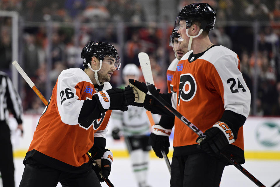 Philadelphia Flyers' Sean Walker, left, greets Nick Seeler (24) after scoring during the first period of an NHL hockey game against the Dallas Stars, Thursday, Jan. 18, 2024, in Philadelphia. (AP Photo/Derik Hamilton)