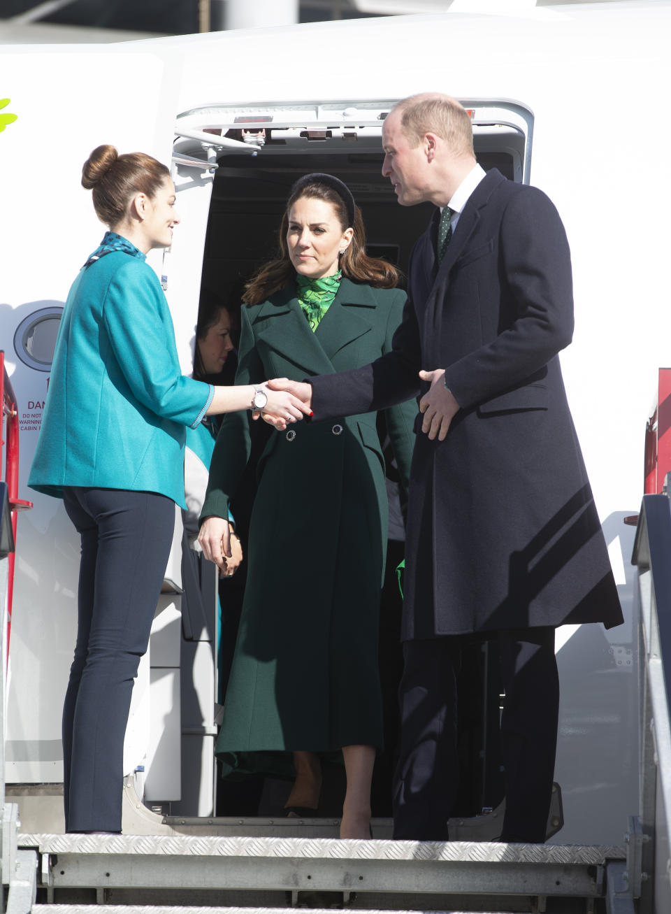 The Duke and Duchess of Cambridge walk down the steps of the plane as they arrive at Dublin International Airport ahead of their three day visit to the Republic of Ireland.