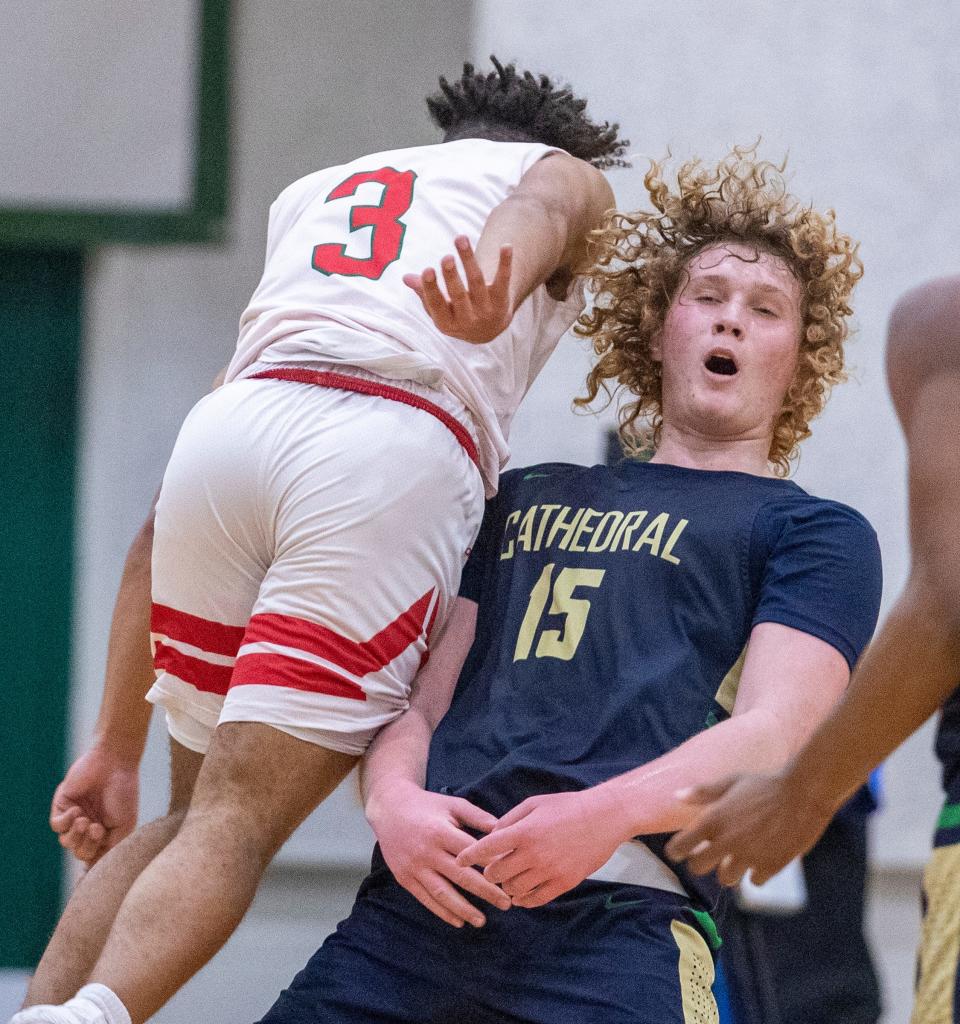 Cathedrals Jake Davis (15) takes a charge from Lawrence North's Kayden Beatty (3) in the 2021 sectional.