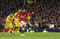 Manchester United's Bruno Fernandes scores his side's second goal by penalty during the English Premier League soccer match between Manchester United and Sheffield at the Old Trafford Stadium in Manchester, England, Wednesday, April 24, 2024. (Martin Rickett/PA via AP)