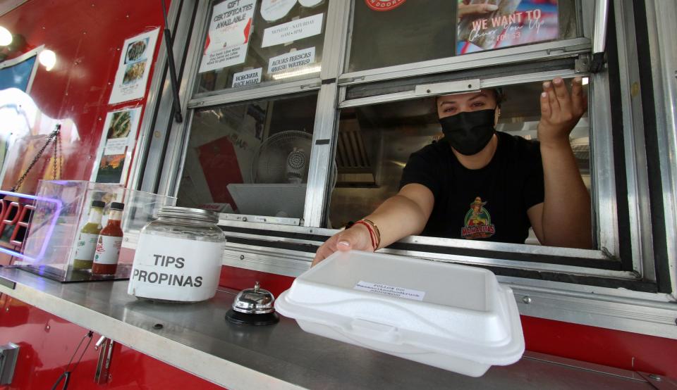  Vanesa Gomez hands out an order from her La Mamacita food truck on West Franklin Boulevard Tuesday morning, August 17, 2021.