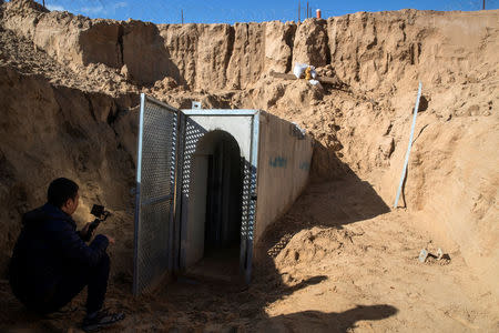 An Israeli soldier sits next to an entrance to what the Israeli military say is a cross-border attack tunnel dug from Gaza to Israel, on the Israeli side of the Gaza Strip border near Kissufim January 18, 2018. REUTERS/Jack Guez/Pool