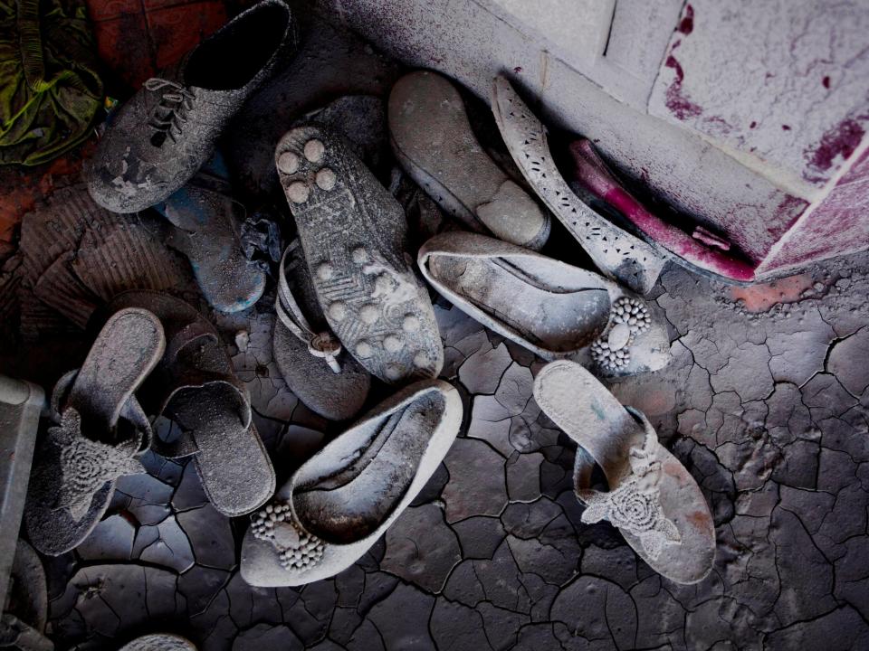 Shoes left behind and covered in ash from Mount Sinabung.