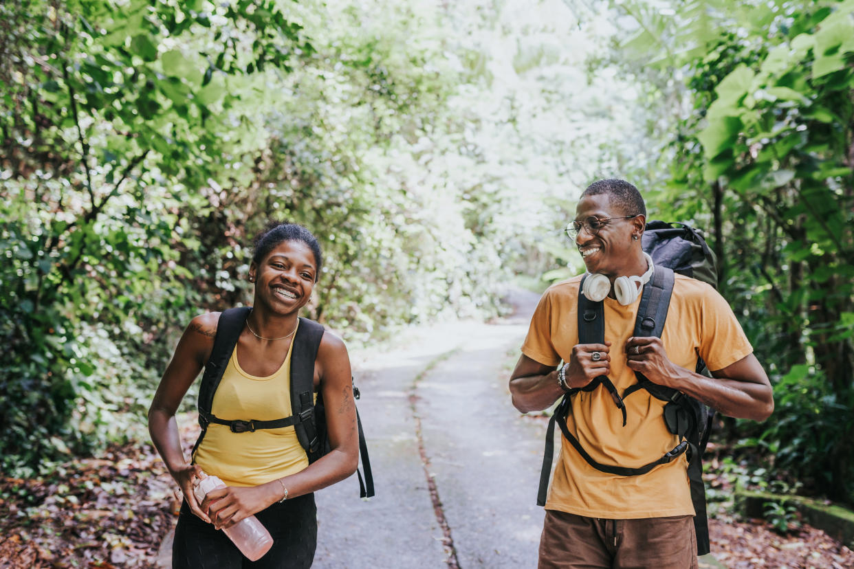 Man and woman walking in the forest park