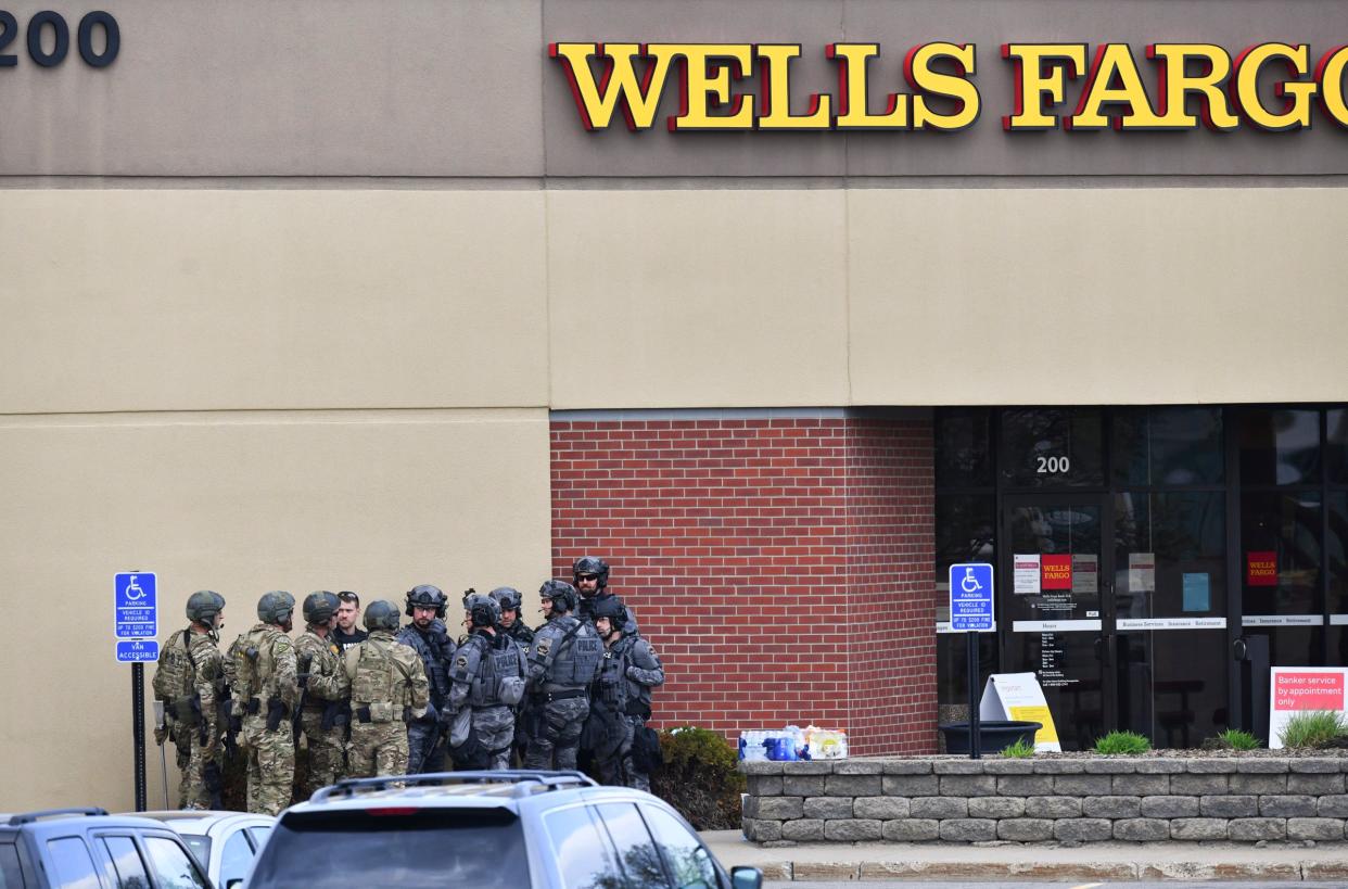 <p>Law enforcement officers gather near the entrance of a Wells Fargo Bank branch Thursday, 6 May 2021, in St Cloud, Minnesota</p> (Associated Press)