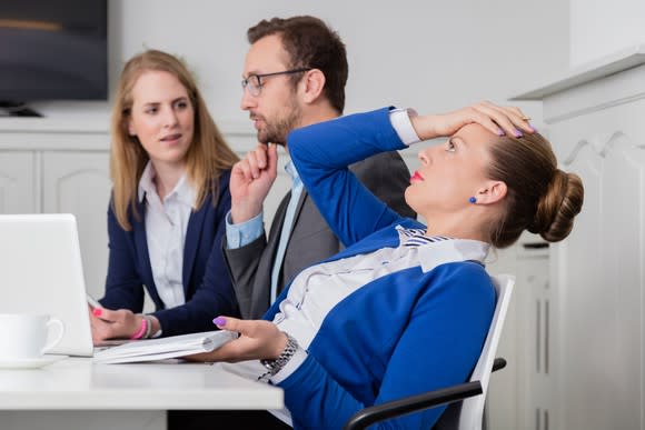 Woman putting her hand on her head in frustration.