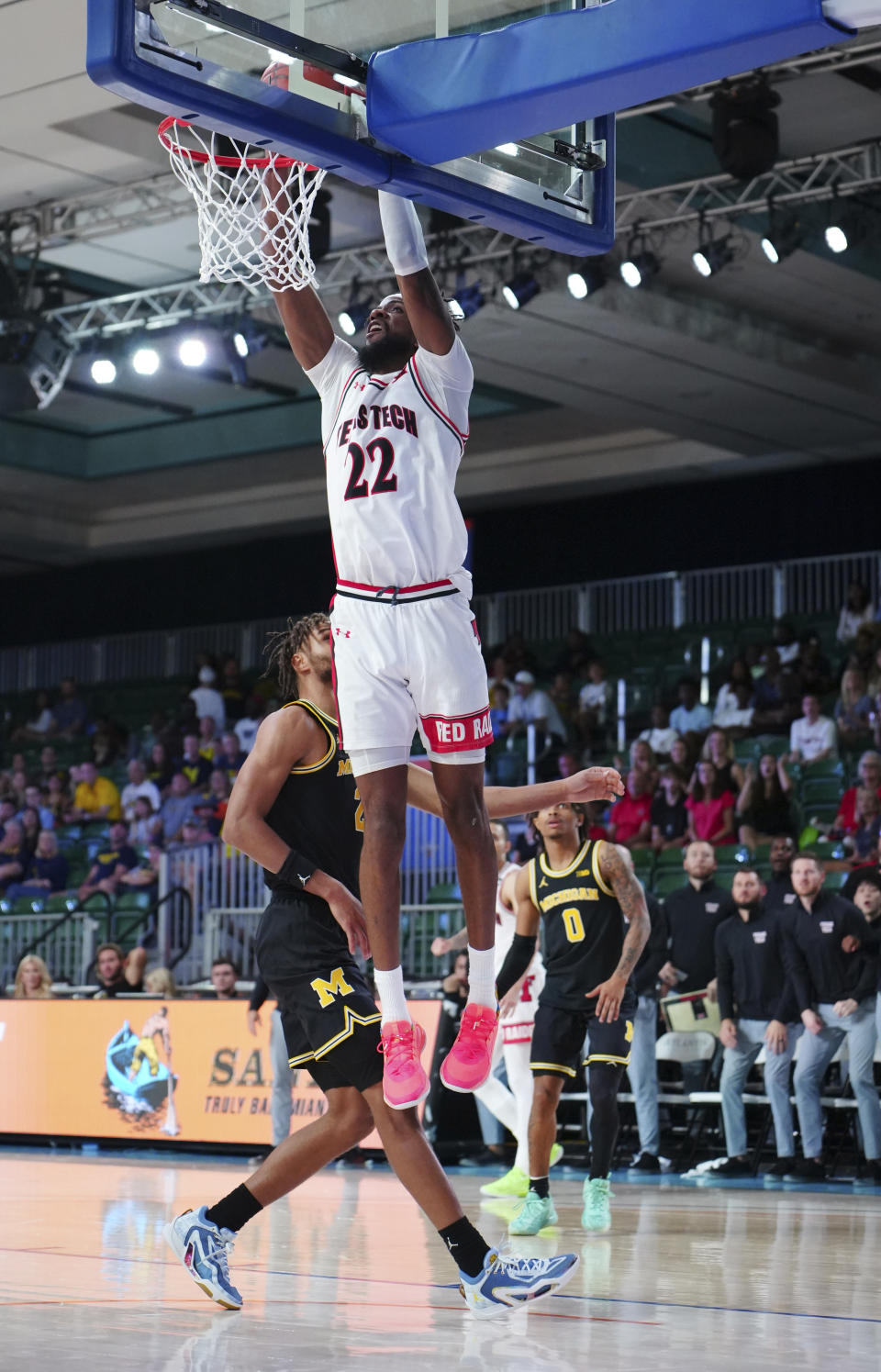 In a photo provided by Bahamas Visual Services, Texas Tech's Warren Washington dunks against Michigan during the second half of an NCAA college basketball game in the Battle 4 Atlantis at Paradise Island, Bahamas, Friday, Nov. 24, 2023. (Ronnie Archer/Bahamas Visual Services via AP)