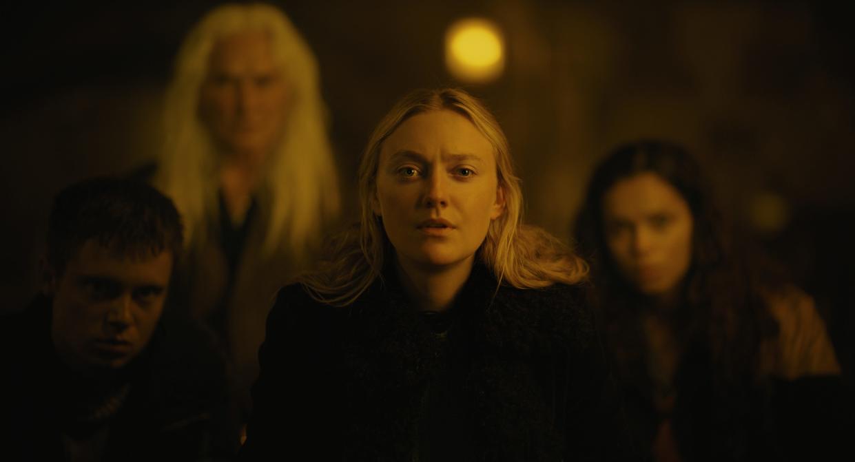 Mina (Dakota Fanning, center) ventures into woods and finds her way in with a group of strangers (Oliver Finnegan, Olwen Fouéré and Georgina Campbell) watched nightly by odd forest creatures in "The Watchers."