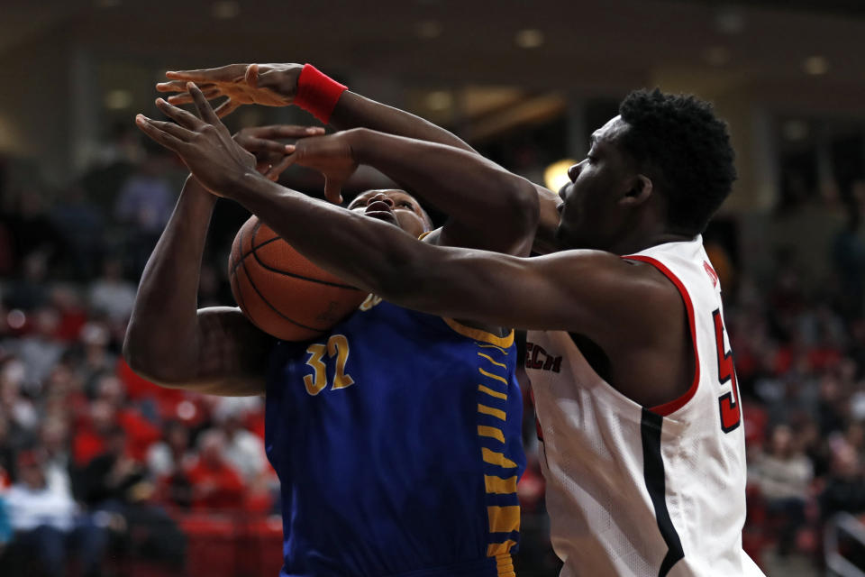 Texas Tech's Russel Tchewa (54) blocks the ball as Cal State Bakersfield's Shawn Stith (32) travels during the first half of an NCAA college basketball game Sunday, Dec. 29, 2019, in Lubbock, Texas. (AP Photo/Brad Tollefson)