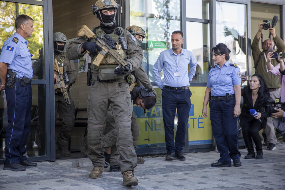 Kosovo police members of Special Intervention Unit escort the arrested Serb gunmen out of the court after the Kosovo shootout in capital Pristina, on Tuesday, Sept. 26, 2023. Sunday's clash was one of the worst since Kosovo declared independence from Serbia in 2008. It came as the European Union and the U.S. are trying to mediate and finalize years long talks on normalizing ties between the two Balkan states. (AP Photo/Visar Kryeziu)