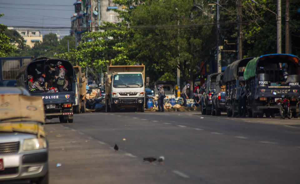 Soldiers and police use trucks to remove improvised barricades set up by anti-coup protesters and residents to secure a neighborhood from security forces in Yangon, Myanmar, Thursday, March 18, 2021. (AP Photo)