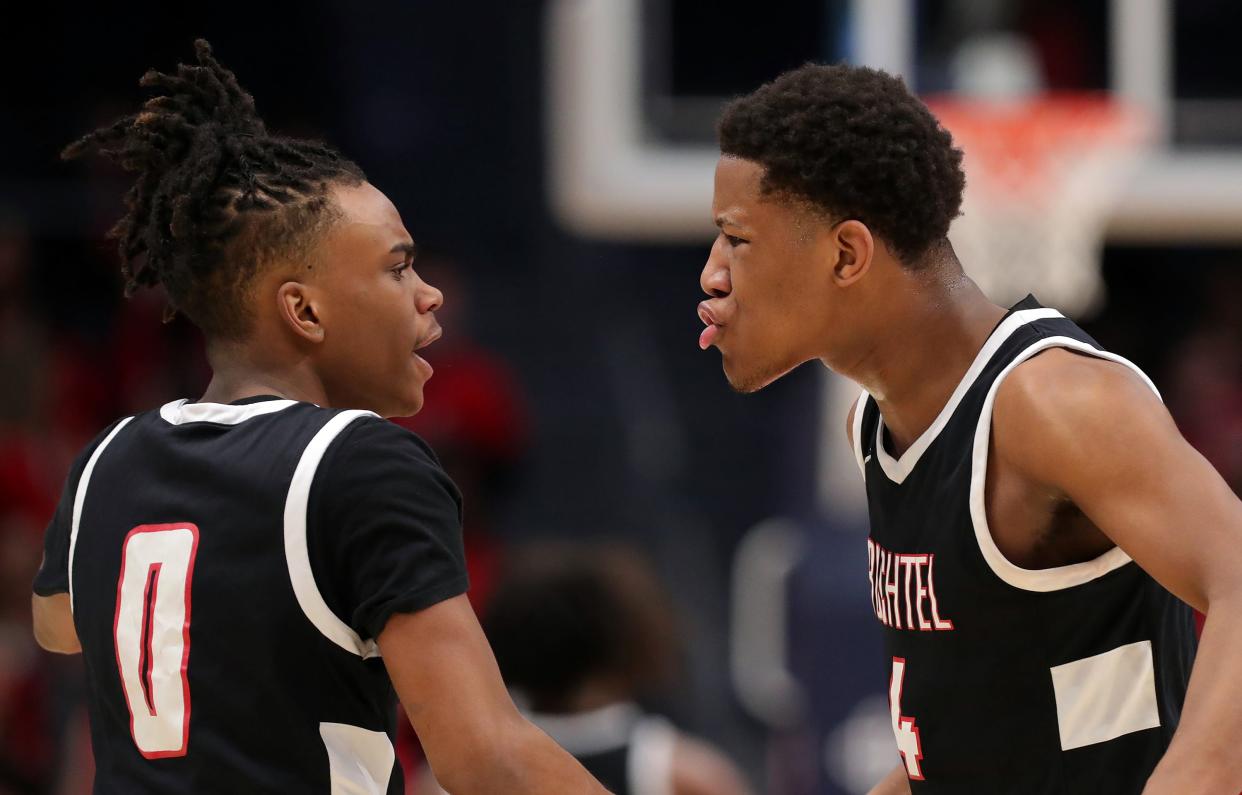 Buchtel guard Jayden Maxwell, right, celebrates with Diaire Pride Jr. as the Griffins go on a 8-0 run against Lutheran West during the OHSAA Division II state final March 19 in Dayton.