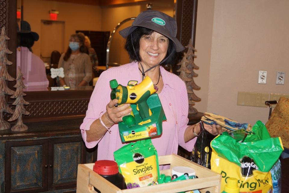 Columnist Mary Lee Minor won the grand prize at Region 14's meeting at the Inn at Honey Run. It included almost every product made by Scott's Company in Orrville.