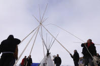 Members of the Oglala Lakota tribe erect a tipi inside of the Oceti Sakowin camp as "water protectors" continue to demonstrate against plans to pass the Dakota Access pipeline near the Standing Rock Indian Reservation, near Cannon Ball, North Dakota, U.S., December 2, 2016. REUTERS/Lucas Jackson