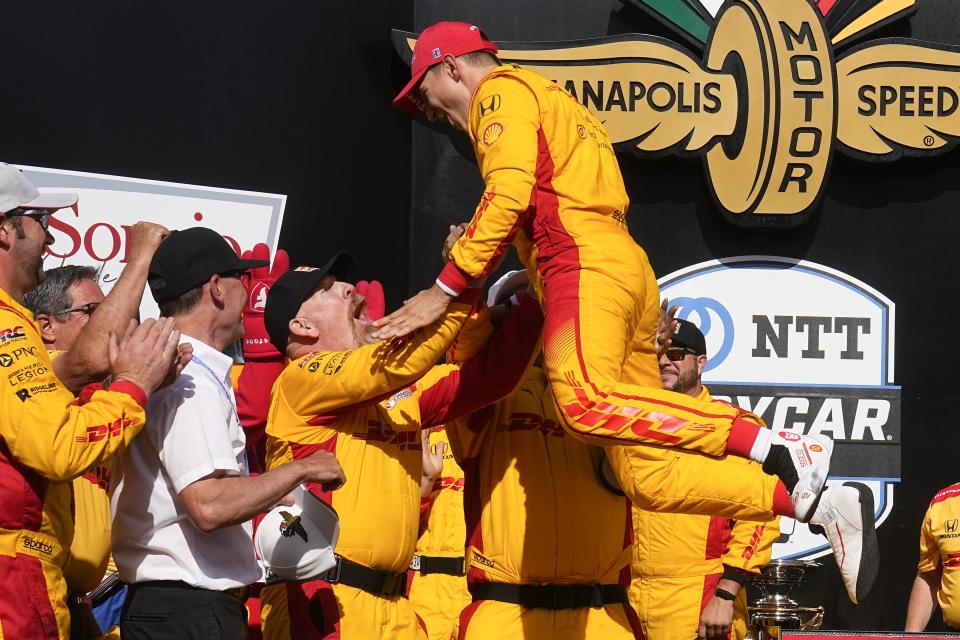 Alex Palou, of Spain, leaps into his crew after winning the IndyCar Grand Prix auto race at Indianapolis Motor Speedway, Saturday, May 11, 2024, in Indianapolis. (AP Photo/Darron Cummings)
