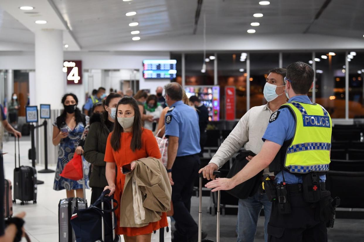Qantas passengers wait to board a flight at Sydney airport.