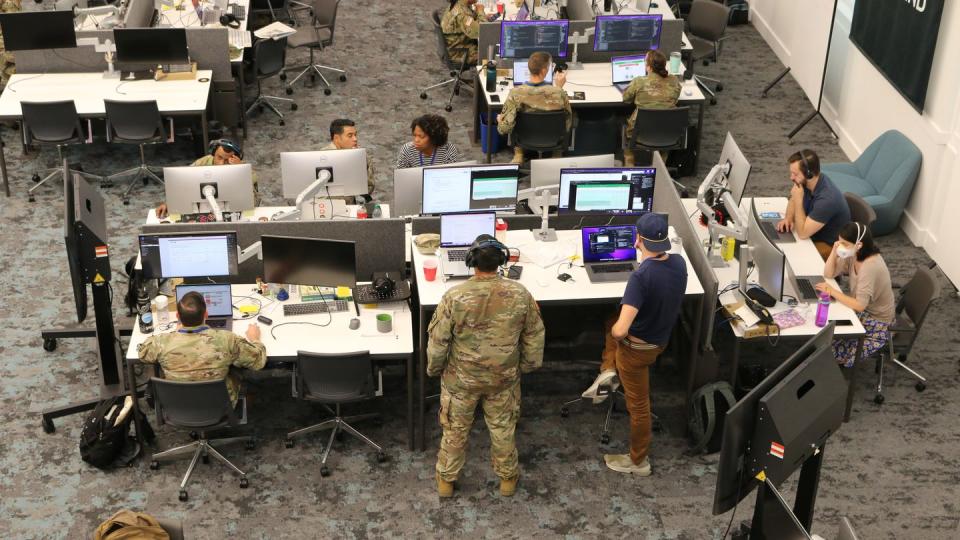 Soldiers and contractors at the Army Software Factory in Austin, Texas, hold a morning meeting on Sept. 26, 2022. (Davis Winkie/Army Times)