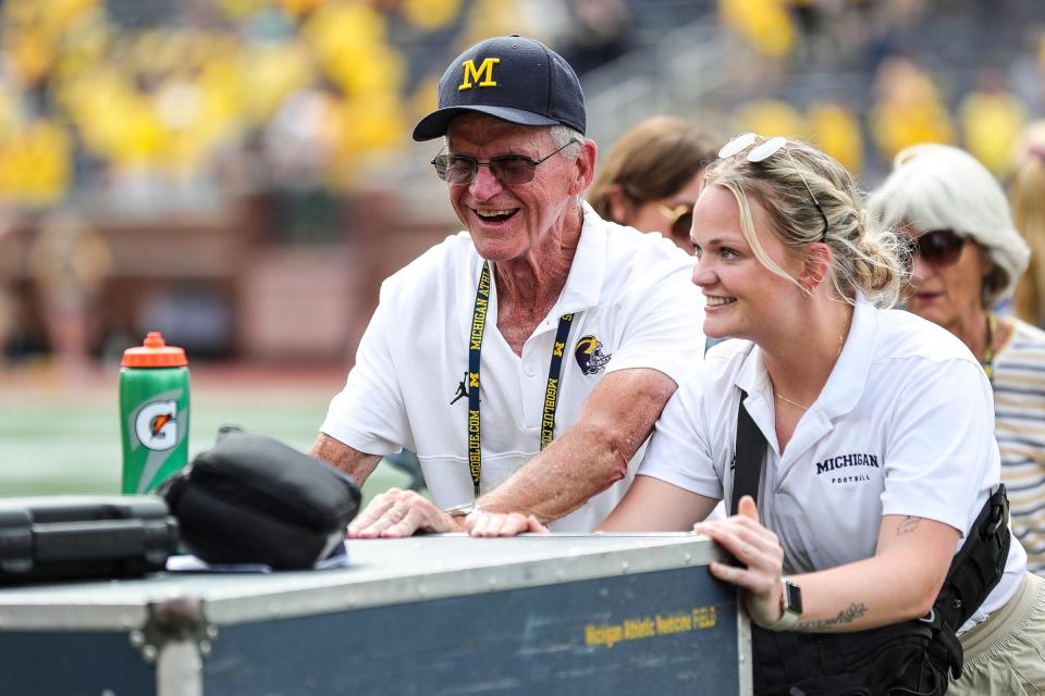 Jim Harbaugh's father, Jack, helps Michigan football staff push a container after U-M's 30-3 win on Saturday, Sept. 2, 2023, at Michigan Stadium.