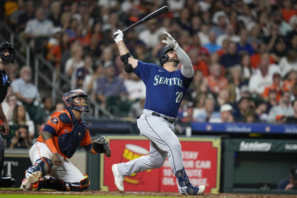 Seattle Mariners' Mike Ford, right, hits a solo home run during the sixth inning of a baseball game against the Houston Astros, Friday, Aug. 18, 2023, in Houston. (AP Photo/Eric Christian Smith)