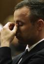 Oscar Pistorius puts his hand to his face as he listens to forensic evidence being given in court in Pretoria, South Africa, Wednesday, April 16, 2014. Pistorius is charged with the murder of his girlfriend, Reeva Steenkamp, on Valentines Day in 2013. (AP Photo/Gianluigi Guercia, Pool)