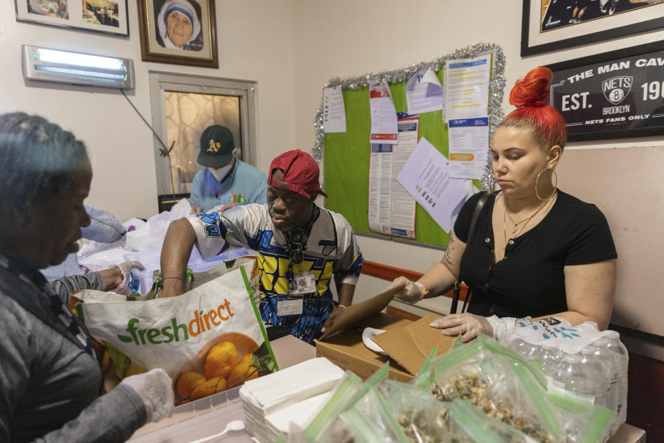 Angela Bagriy, right, organizes lunch boxes at Community Help in Park Slope, a soup kitchen and food pantry better known as CHiPS, on Friday, June 16, 2023 in New York. Charitable giving in the United States declined in 2022. The downturn in giving has led to issues at CHiPS, as it has in many charities across the country. (AP Photo/Jeenah Moon)