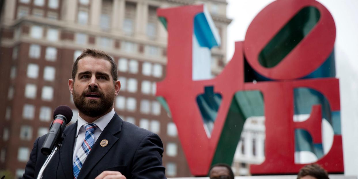 Brian Sims, a Pennsylvania state representative, speaking into a microphone in front of the "Love" sculpture in Philadelphia's John F. Kennedy Plaza.