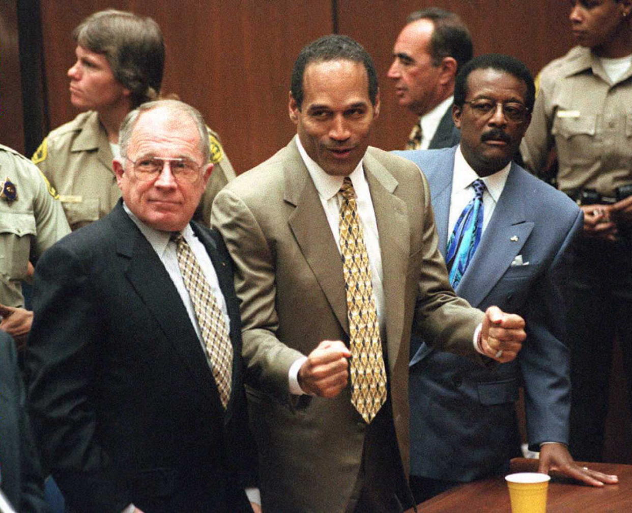 LOS ANGELES, CA - OCTOBER 3:  Murder defendant O.J. Simpson (C) listens to the not guilty verdict with his attorneys F. Lee Bailey (L) and Johnnie Cochran Jr (R). Simpson was found not guilty of killing his ex-wife Nicole Brown-Simpson and her friend Ron Goldman.                AFP PHOTO  (Photo credit should read MYUNG J. CHUN/AFP via Getty Images)