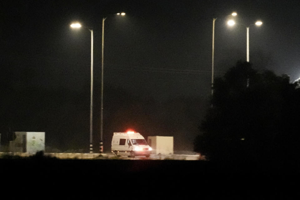 An Israeli ambulance is seen leaving the Kerem Shalom crossing between Israel and Gaza, in Israel, on Friday, Nov. 24, 2023. A four-day cease-fire in the Israel-Hamas war has begun in Gaza as part of an agreement that Qatar helped broker. Twenty-four hostages were freed Friday after seven weeks of captivity. The group included 13 Israeli citizens, 10 Thai citizens and a Filipino citizen. Israel was expected to release 39 Palestinian prisoners later Friday. (AP Photo/Leo Correa)