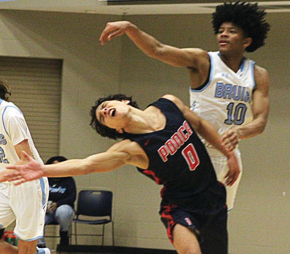 Bartlesville High's David Castillo, right, has proven he can absorb physical play, such as this encounter of the bruising kind his freshman year (2020-21) against  a Ponca City High guard at the Bruin Fieldhouse. Castillo finished with 43 points in the 74-66 victory.