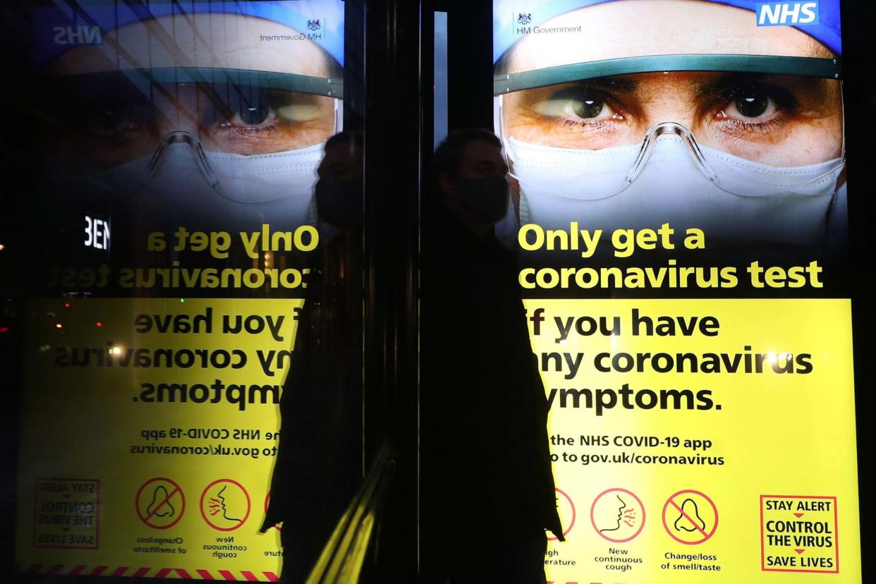 An NHS Covid test information sign on a bus shelter in central London: PA