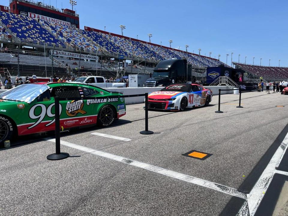 The NASCAR Cup Series cars of Daniel Suarez (99) and Ricky Stenhouse (47) sit on pit road ahead of the Goodyear 400 in Darlington, S.C., on May 12, 2024.
