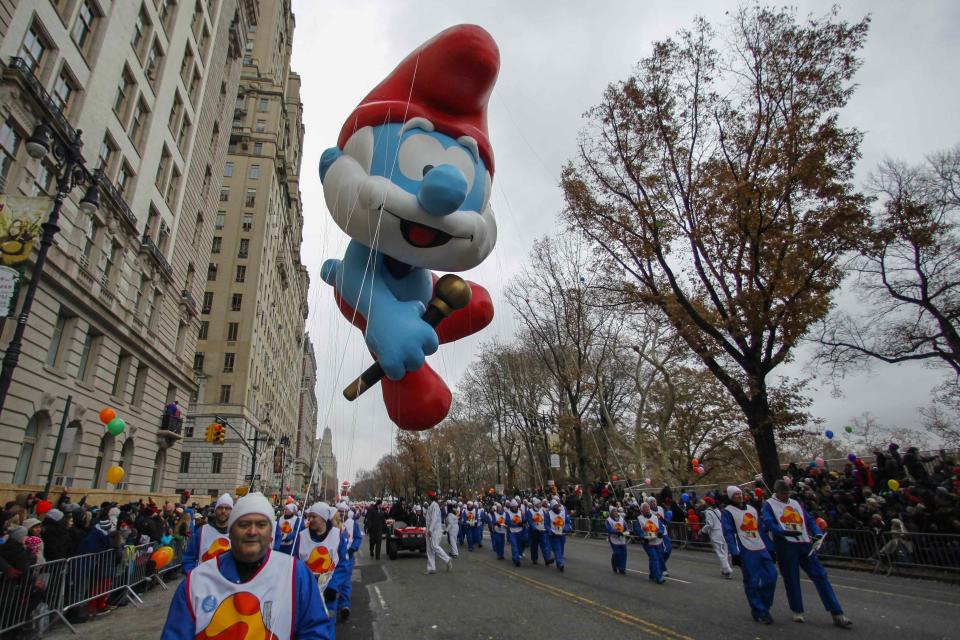 The Papa Smurf balloon floats down Central Park West during the 88th Macy's Thanksgiving Day Parade in New York