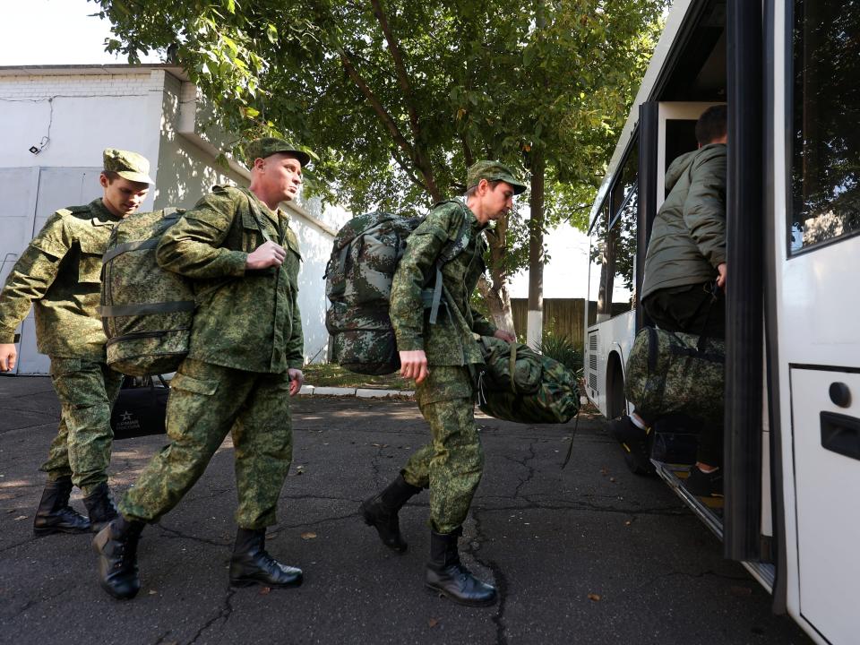 Russian recruits board a bus.
