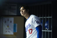 Los Angeles Dodgers' Shohei Ohtani watches from the dugout during the first inning of a baseball game against the St. Louis Cardinals Friday, March 29, 2024, in Los Angeles. (AP Photo/Jae C. Hong)