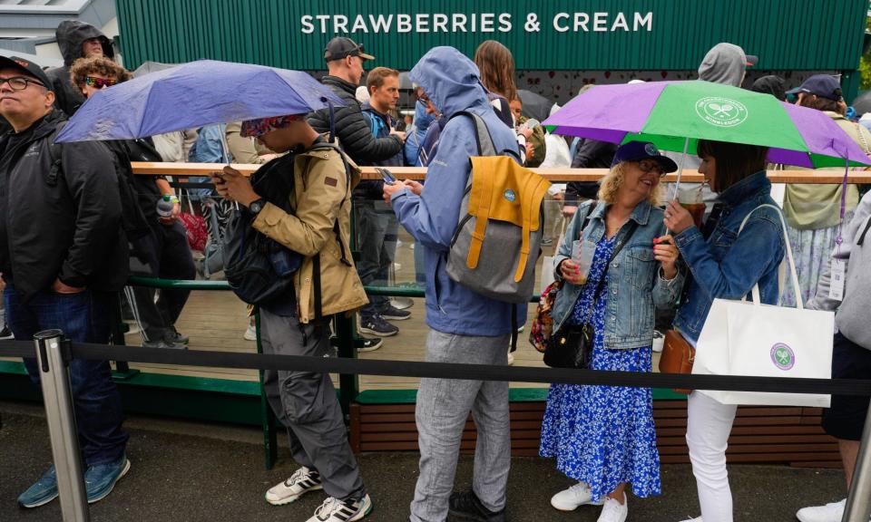 <span>Queuing is an essential part of Wimbledon, whether to get in, get to a show court, or just for strawberries.</span><span>Photograph: Kirsty Wigglesworth/AP</span>