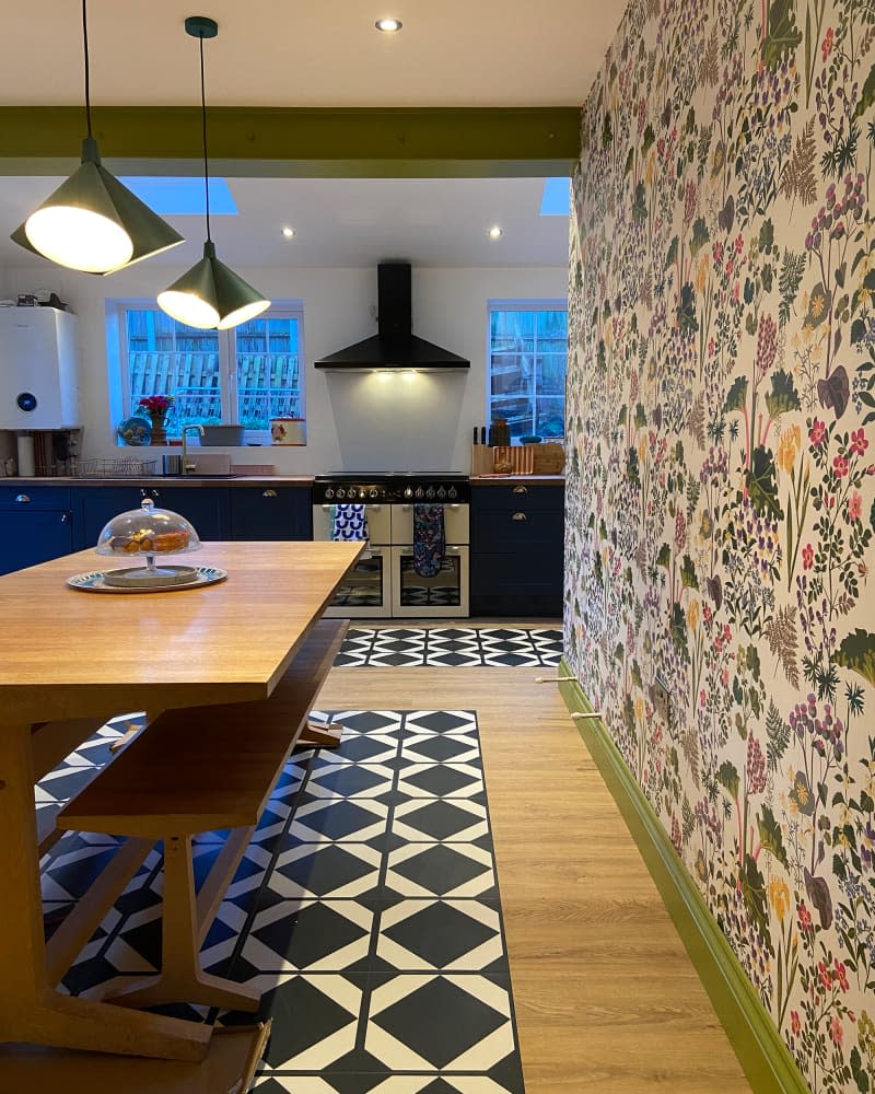 Black and white kitchen mat in colorful kitchen and dining room.