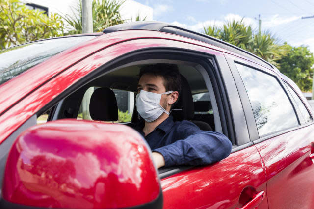 Male driver with protective mask